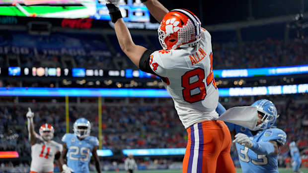 Dec 3, 2022; Charlotte, North Carolina, USA; Clemson Tigers tight end Davis Allen (84) catches a touchdown in front of North Carolina Tar Heels linebacker Cedric Gray (33) during the first quarter of the ACC Championship game at Bank of America Stadium. Mandatory Credit: Bob Donnan-USA TODAY Sports